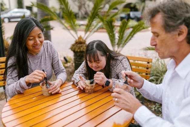 disabled person's waiting exemption in Israel - girl with down syndrome at ice cream parlor with parents